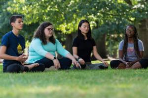 Students meditating on the quad.